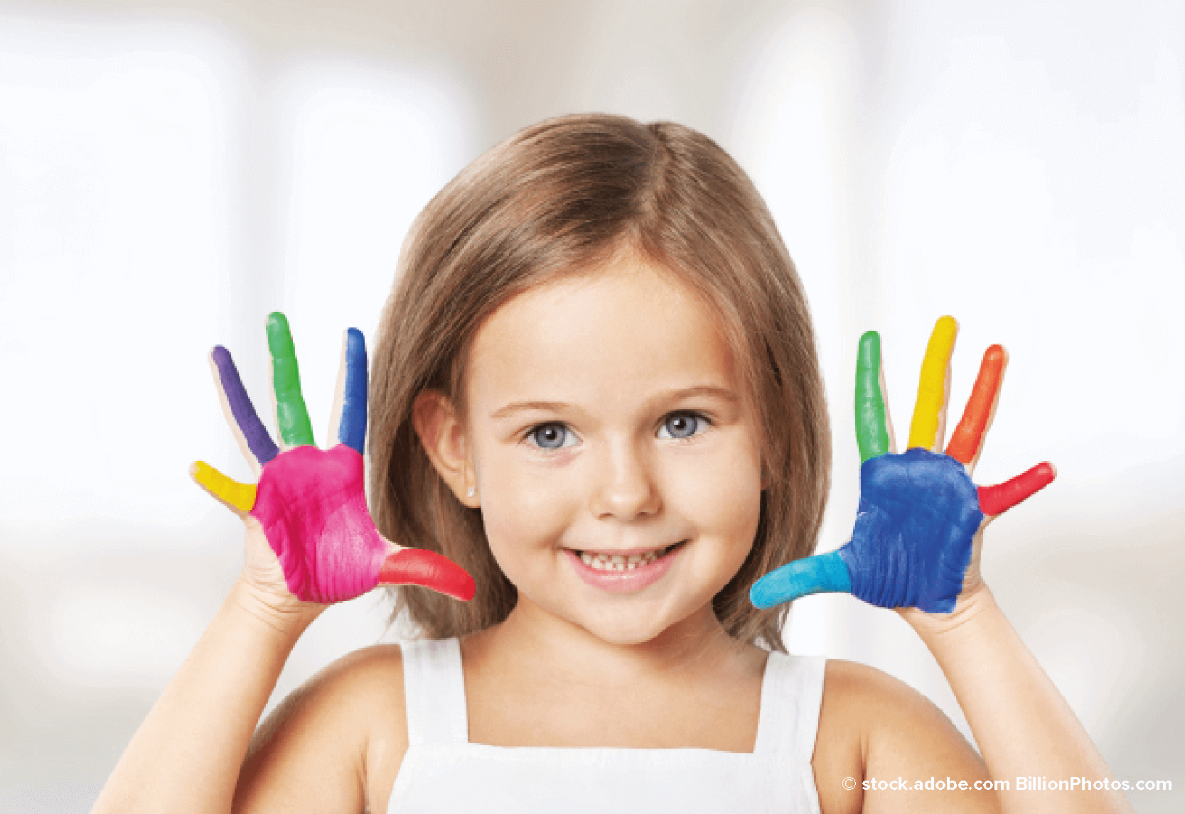 A young girl with paint on her hands