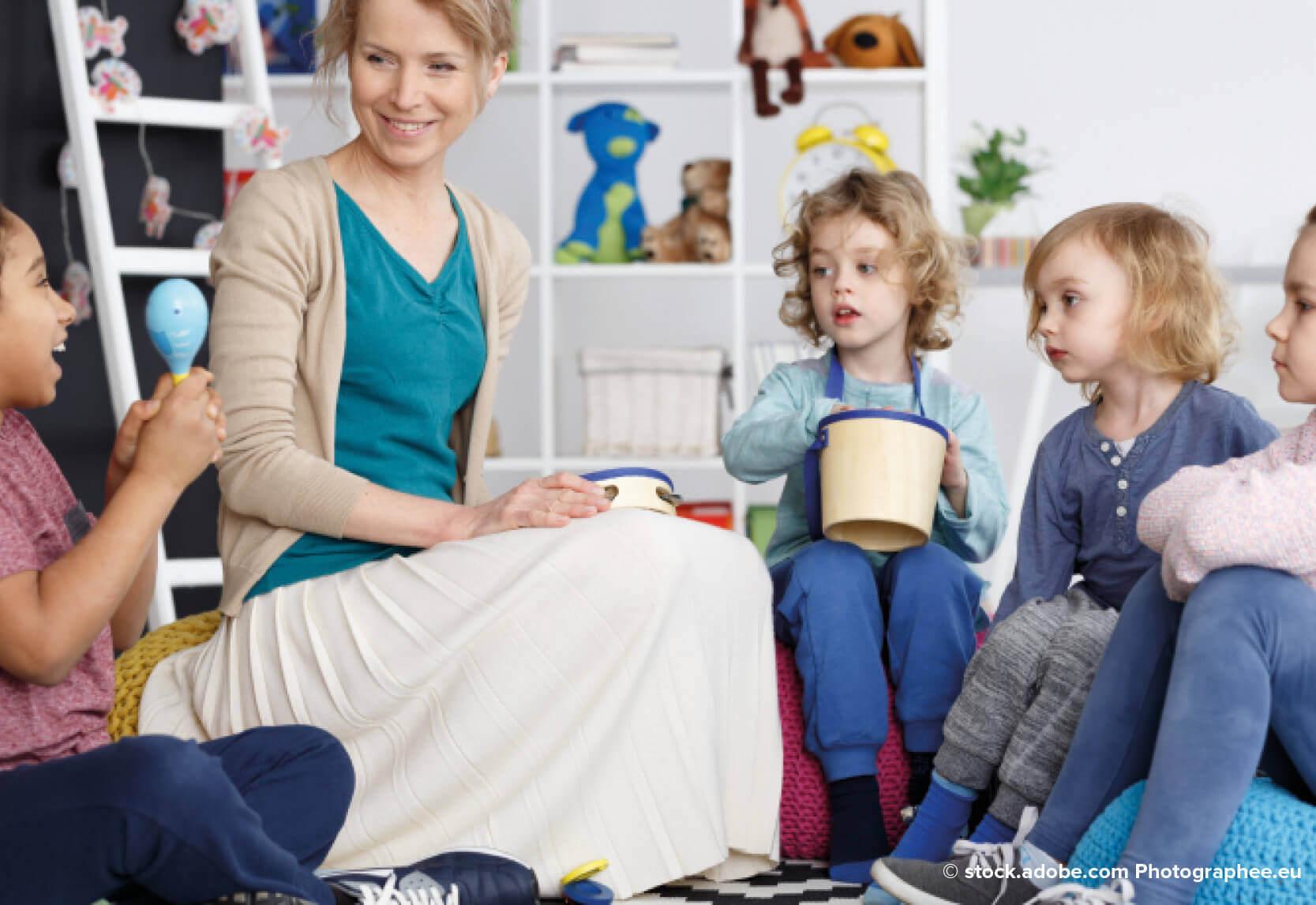 A female teacher in a classroom with a group of small children