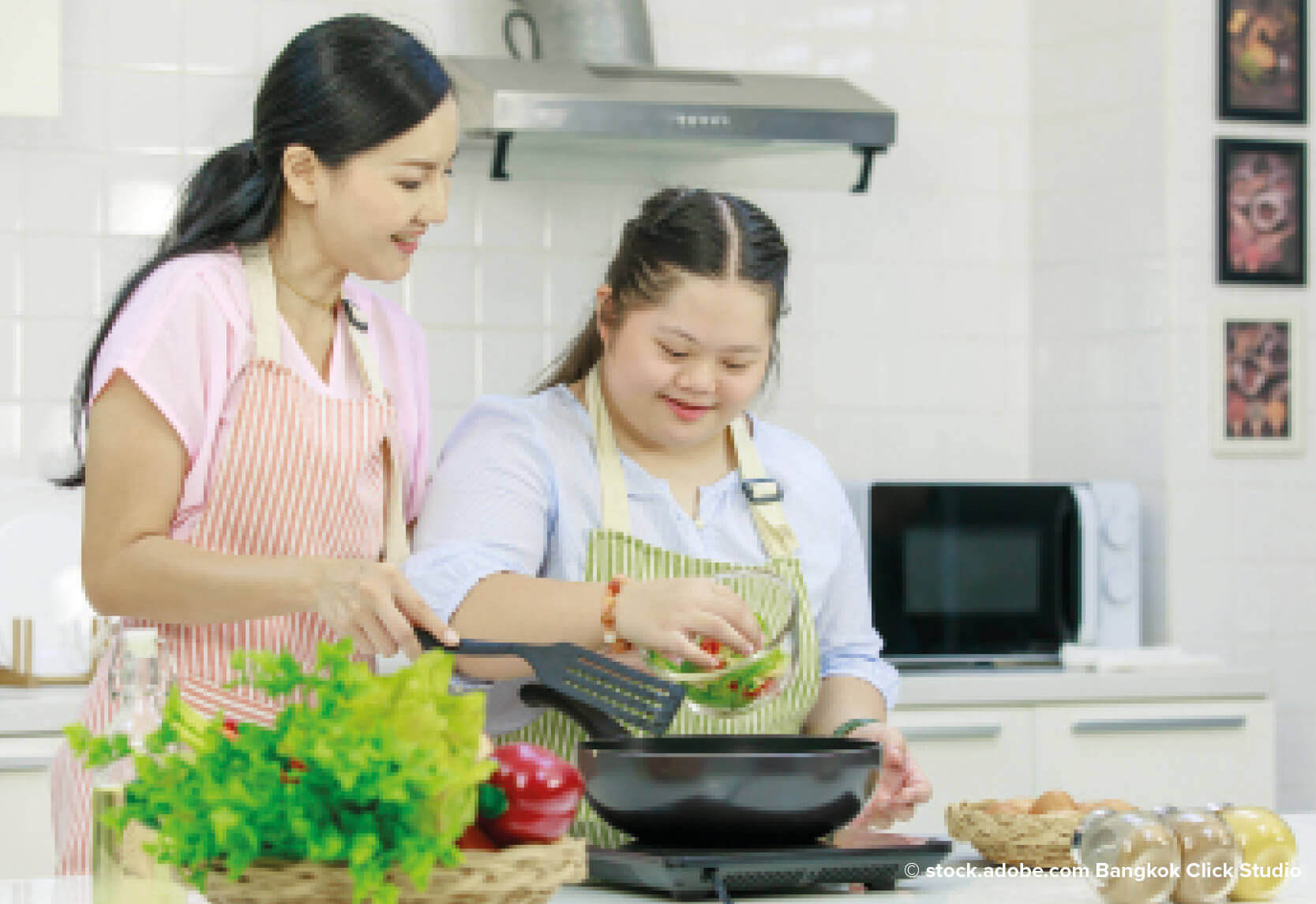 A woman and a girl in a kitchen preparing food